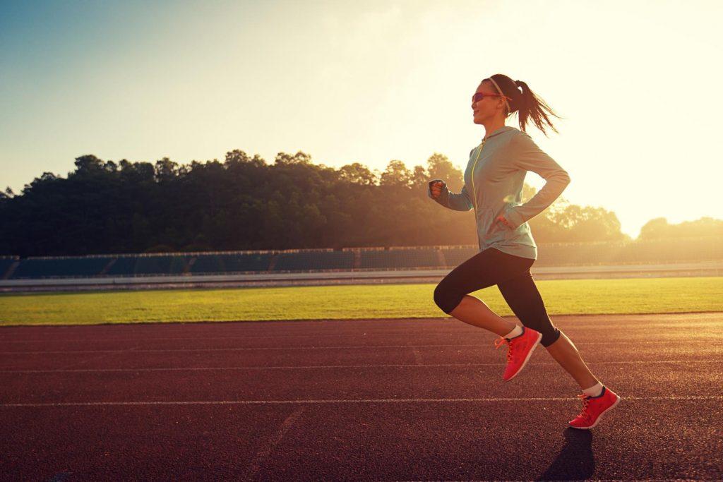 girl running on a running track