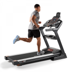 A man in athletic attire running on the Sole F85 treadmill