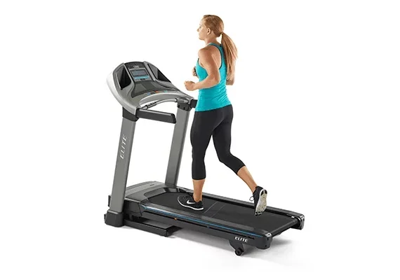 A fit woman in athletic attire running on the Horizon Elite T5 Treadmill