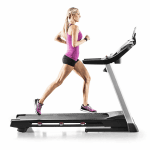 A fit woman in athletic attire running on the ProForm 705 CST Treadmill