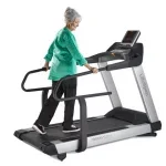 An elderly woman in casual attire walking on the TR8000i Treadmill