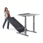 A woman in business casual attire putting together the TR5000 treadmill desk