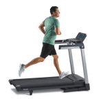 A man in athletic attire running on the TR5500i Treadmill