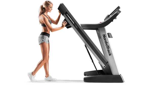 woman folding up a NordicTrack treadmill