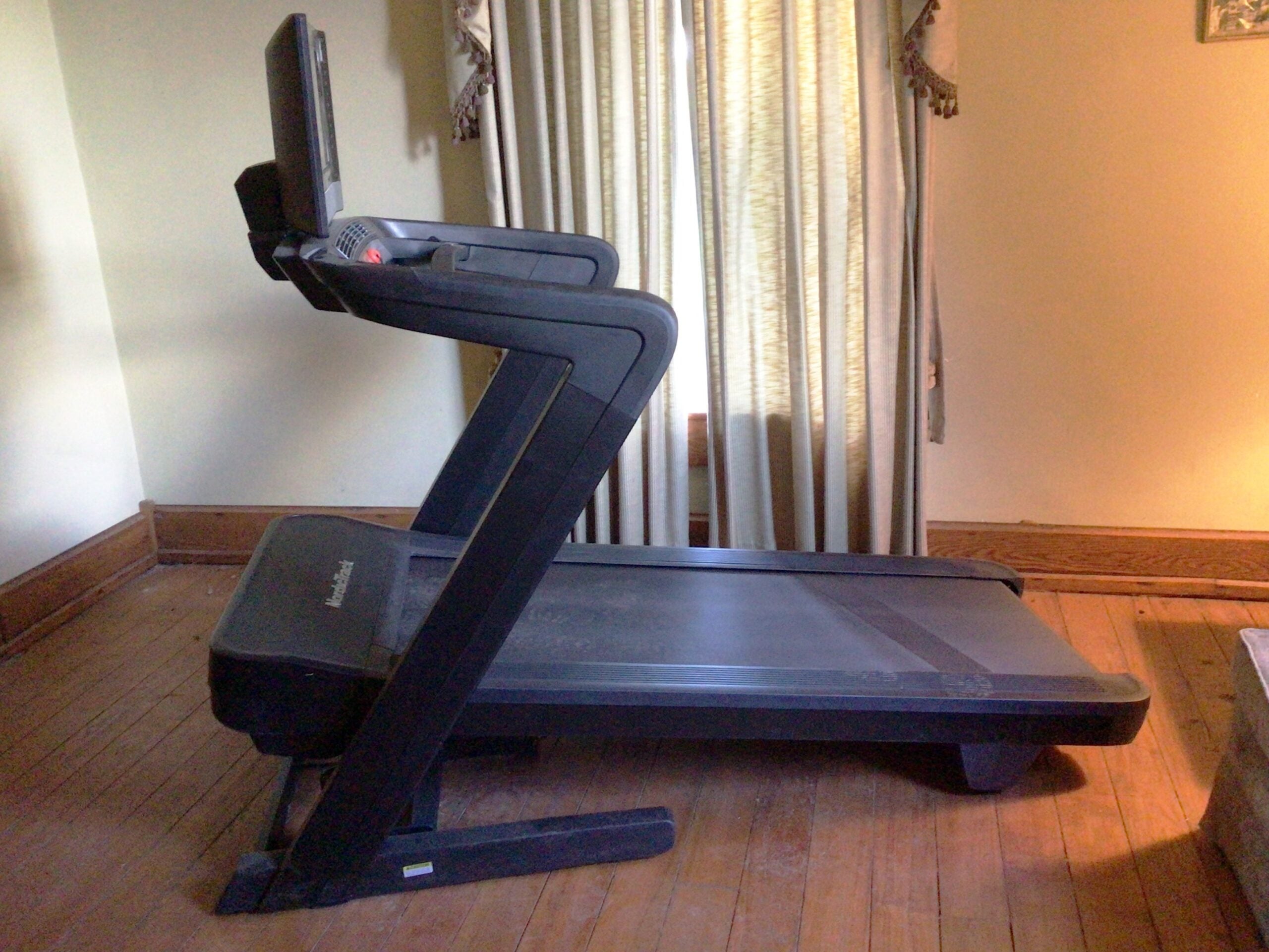 Side view of the 2022 Nordictrack 1750 treadmill on a wooden floor
